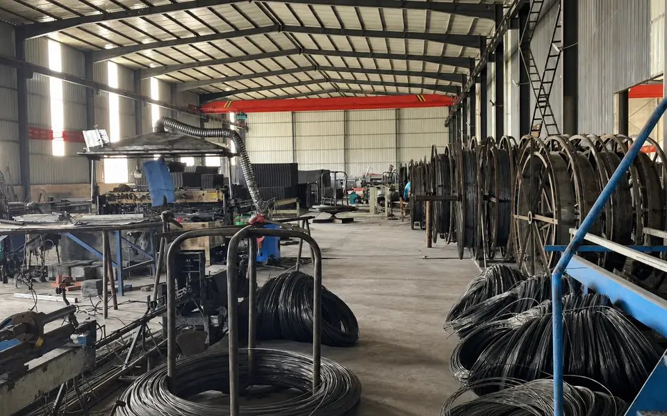 Coiled wire, payoff stands and processing equipment inside the Xianhong Mining workshop